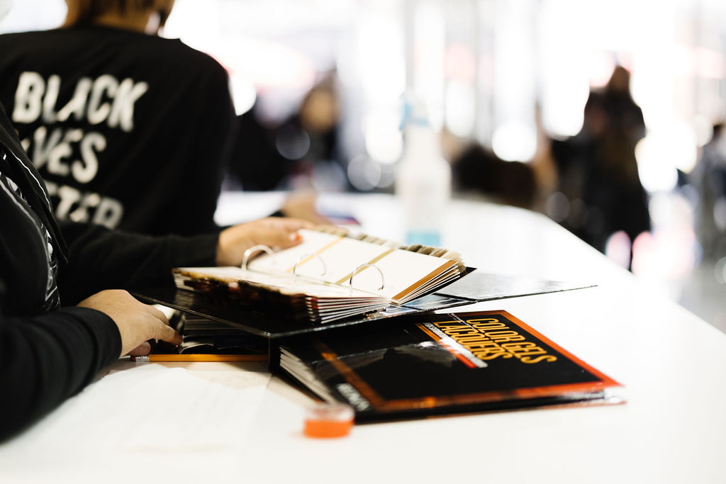 Milady textbooks on a classroom table