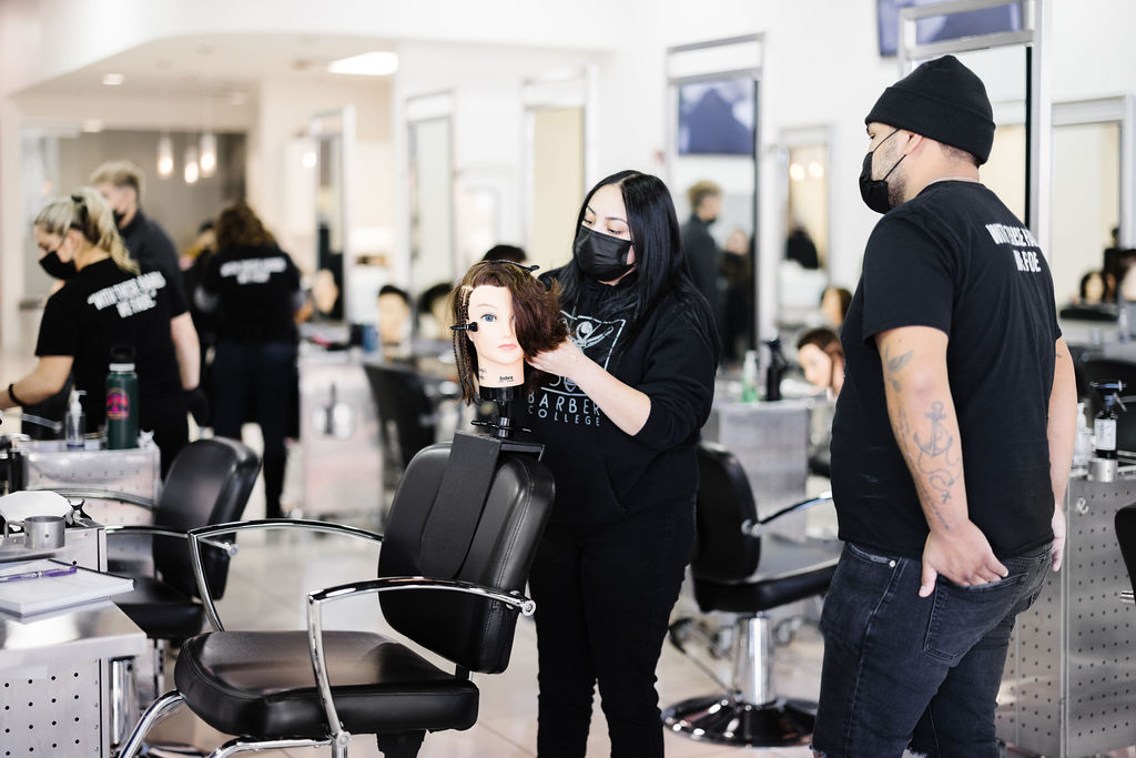 Students practising on mannequins under instructor supervision
